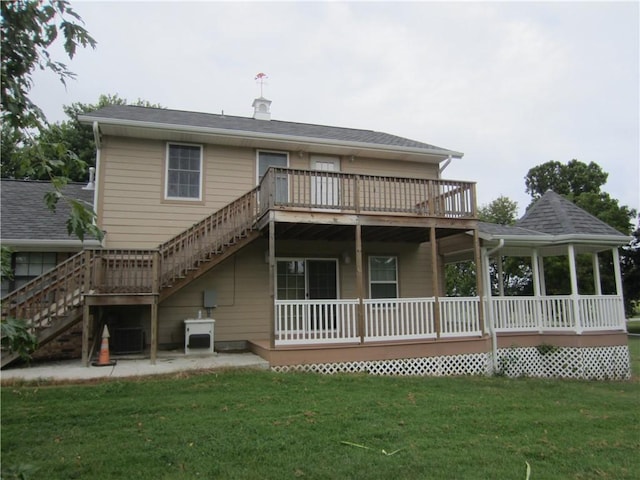 back of house with central AC, stairway, a lawn, and roof with shingles