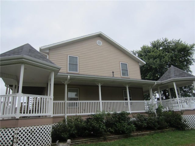 rear view of property with covered porch