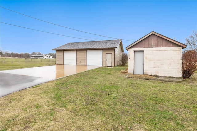 detached garage featuring fence