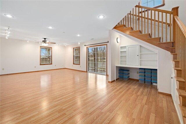 unfurnished living room featuring light wood finished floors, baseboards, a ceiling fan, rail lighting, and recessed lighting