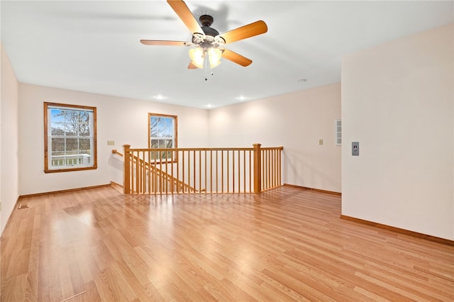 unfurnished room with recessed lighting, baseboards, and light wood finished floors