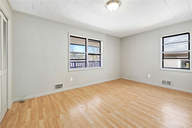 15 White St, Eureka Springs, AR 72632 - spare room with light wood-style flooring, visible vents, and a healthy amount of sunlight