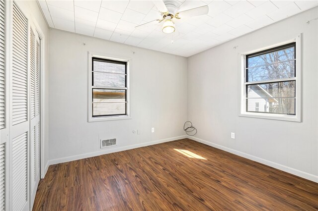 15 White St, Eureka Springs, AR 72632 - unfurnished bedroom with multiple windows, visible vents, baseboards, and wood finished floors
