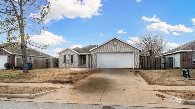 single story home featuring a garage, brick siding, driveway, and fence