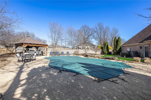 view of swimming pool featuring a fenced in pool, a patio, fence, a gazebo, and central AC