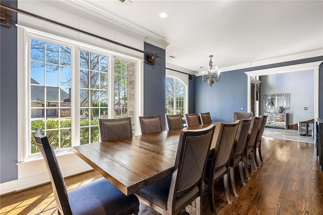 dining area with crown molding, recessed lighting, an inviting chandelier, wood finished floors, and baseboards