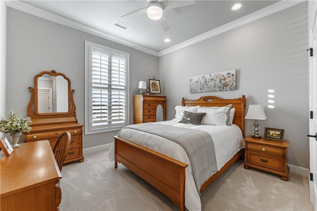 bedroom with light colored carpet, a ceiling fan, baseboards, visible vents, and ornamental molding