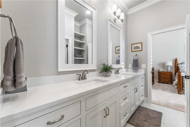 ensuite bathroom featuring ornamental molding, double vanity, and tile patterned floors
