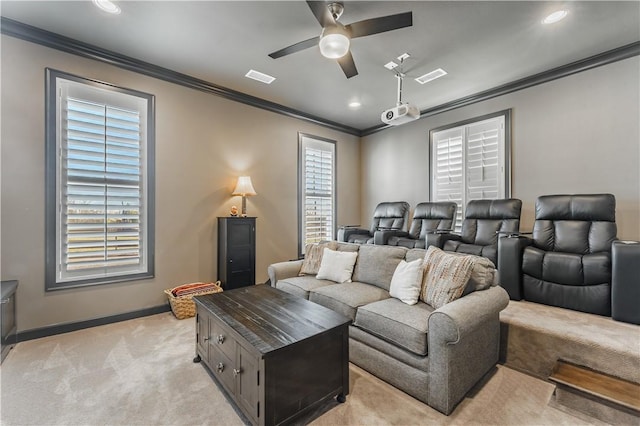 home theater room featuring crown molding, a ceiling fan, light carpet, baseboards, and recessed lighting