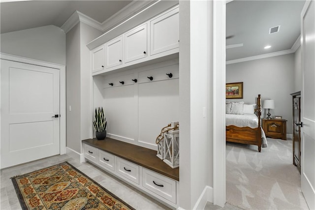 mudroom featuring lofted ceiling, baseboards, visible vents, and crown molding