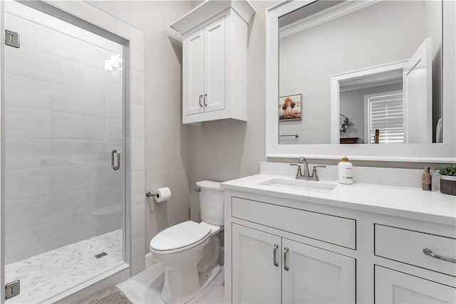 full bath featuring toilet, a stall shower, and vanity