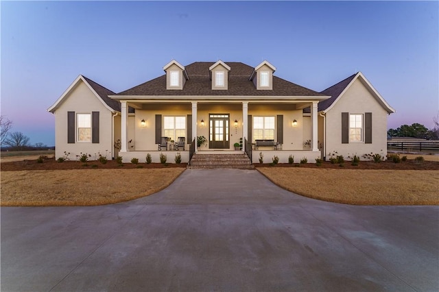 view of front of home featuring covered porch and stucco siding