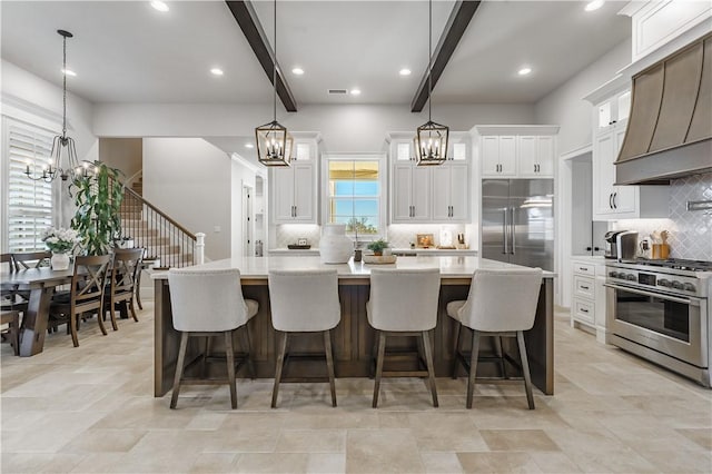 kitchen featuring a notable chandelier, beamed ceiling, custom exhaust hood, and high quality appliances