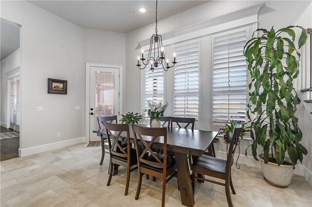 dining space featuring a chandelier, baseboards, and recessed lighting