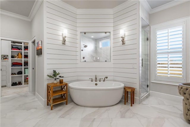 bathroom with ornamental molding, marble finish flooring, a shower stall, a soaking tub, and a walk in closet