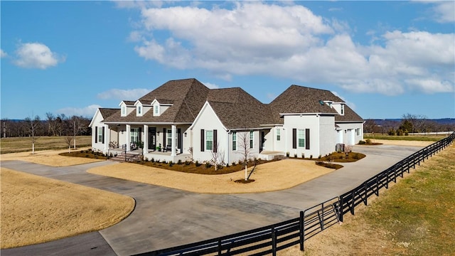 view of front of home featuring driveway, fence, stucco siding, a garage, and a porch