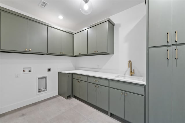 washroom with cabinet space, visible vents, hookup for a washing machine, electric dryer hookup, and a sink