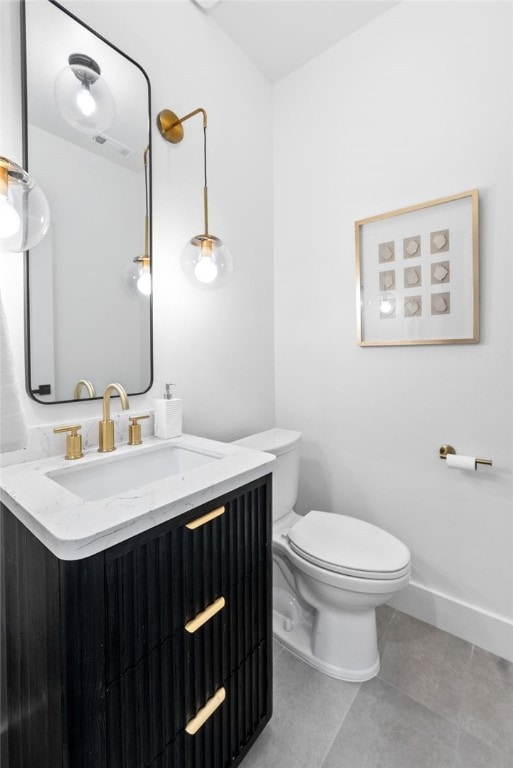 half bath featuring tile patterned flooring, baseboards, vanity, and toilet