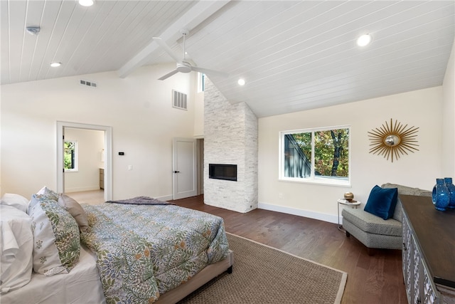 bedroom featuring wood finished floors, visible vents, a fireplace, and multiple windows