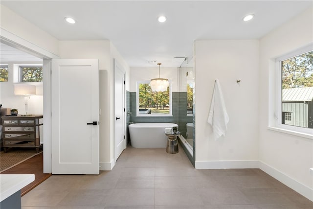 full bathroom featuring a stall shower, recessed lighting, a freestanding tub, and a healthy amount of sunlight