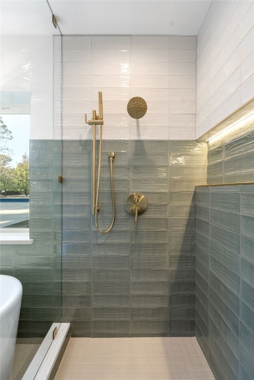 bathroom with a freestanding tub and tiled shower