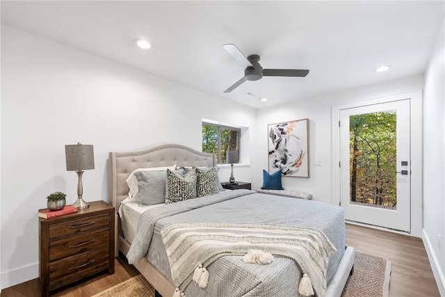 bedroom featuring access to exterior, recessed lighting, and wood finished floors