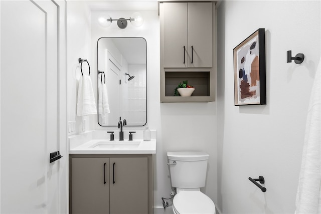 bathroom featuring toilet and vanity