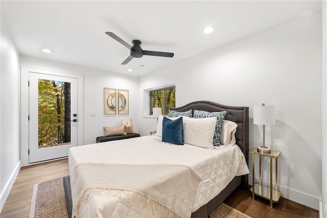 bedroom featuring baseboards, wood finished floors, and recessed lighting