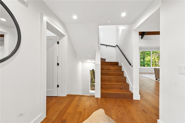 stairway with recessed lighting, baseboards, and wood finished floors