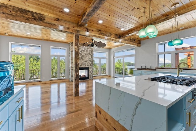 16103 E Ar 12th Hwy, Rogers, AR 72756 - kitchen featuring recessed lighting, gas cooktop, wooden ceiling with exposed beams, light wood-type flooring, and a fireplace