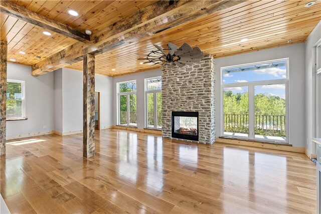 16103 E Ar 12th Hwy, Rogers, AR 72756 - unfurnished living room featuring wooden ceiling with exposed beams, wood finished floors, a fireplace, recessed lighting, and baseboards