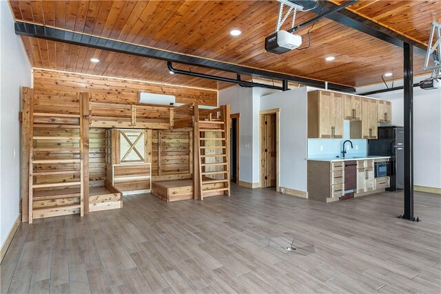 16103 E Ar 12th Hwy, Rogers, AR 72756 - unfurnished living room with baseboards, wood finished floors, wood ceiling with exposed beams, wood walls, and a sink
