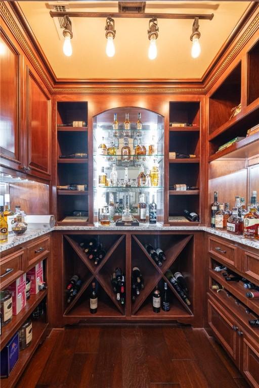 wine room featuring dark wood-style flooring