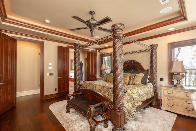 bedroom with a ceiling fan, baseboards, ornamental molding, dark wood-style floors, and a raised ceiling