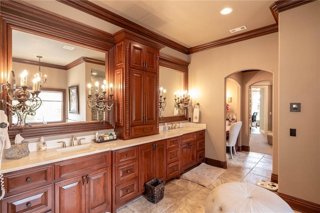 bathroom with double vanity, crown molding, visible vents, and a sink