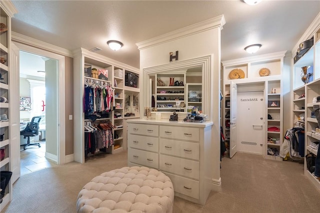 walk in closet with light carpet and visible vents