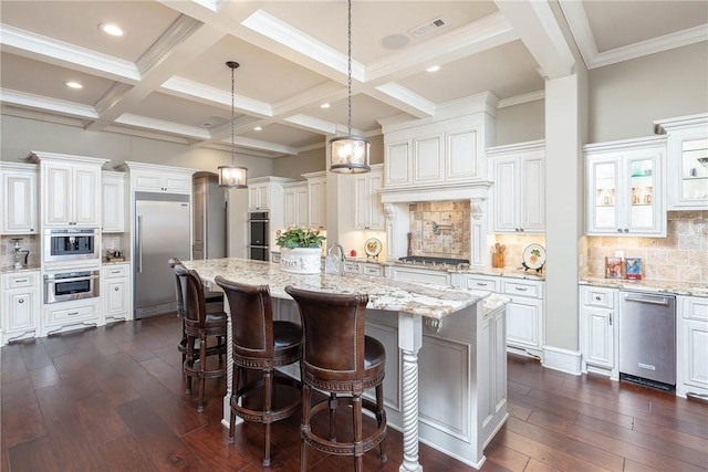 kitchen featuring beam ceiling, dark wood-style flooring, a large island, stainless steel appliances, and coffered ceiling