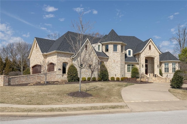 french country home with a shingled roof