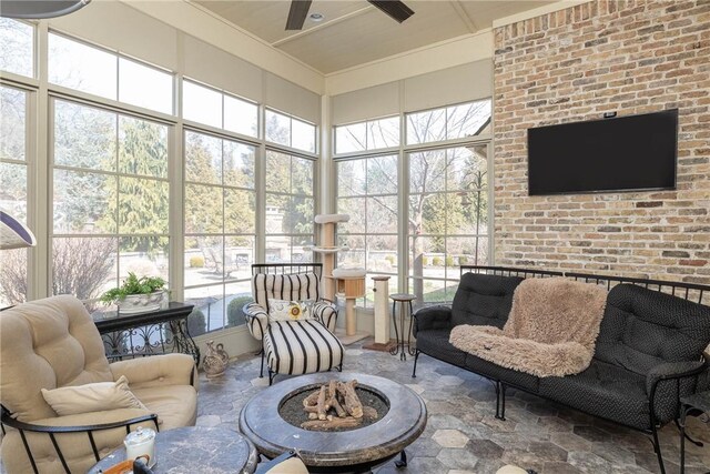 sunroom with a wealth of natural light and a ceiling fan