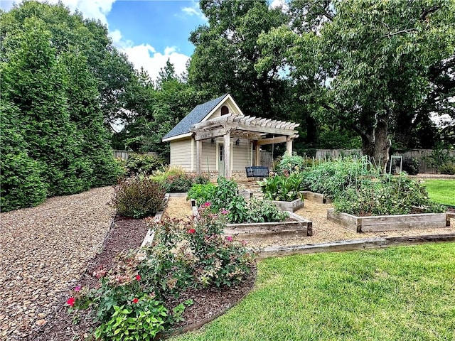 exterior space featuring a garden, fence, and a pergola