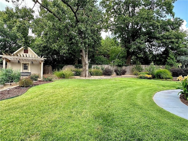 view of yard with fence and a pergola