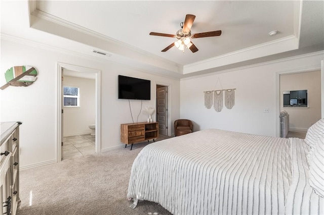 bedroom featuring ornamental molding, visible vents, a raised ceiling, and light colored carpet