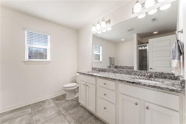 full bath featuring double vanity, a shower stall, visible vents, and a sink