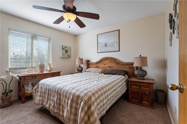 carpeted bedroom featuring baseboards and a ceiling fan