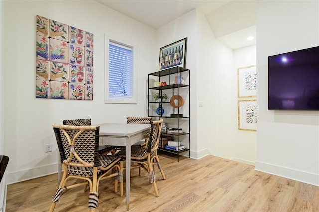 dining room with light wood-type flooring and baseboards