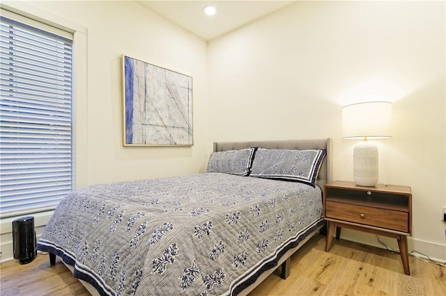 bedroom featuring baseboards and wood finished floors