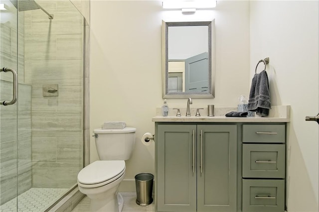 bathroom with vanity, a shower stall, and toilet