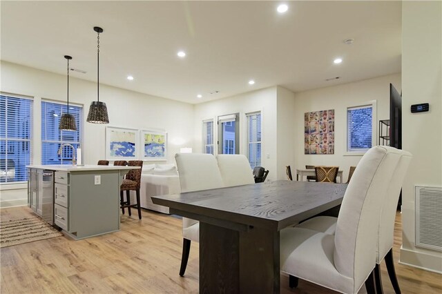 dining space featuring recessed lighting, visible vents, and light wood-style floors