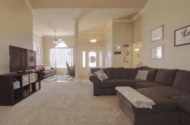 carpeted living area with a high ceiling and crown molding