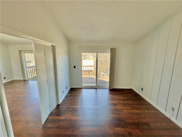 spare room featuring dark wood-type flooring